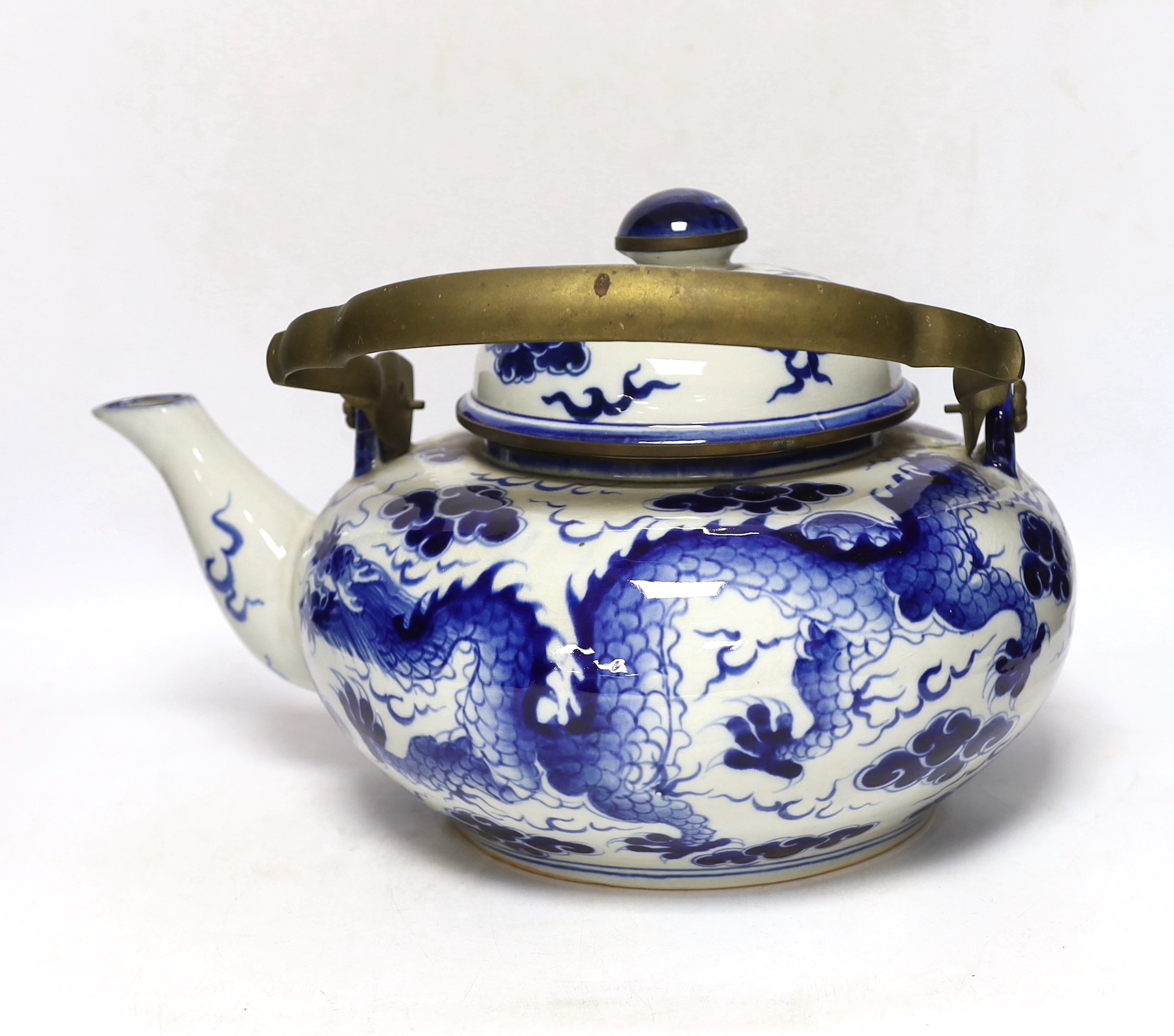 A large Chinese blue and white ‘dragon’ teapot, 38cm wide